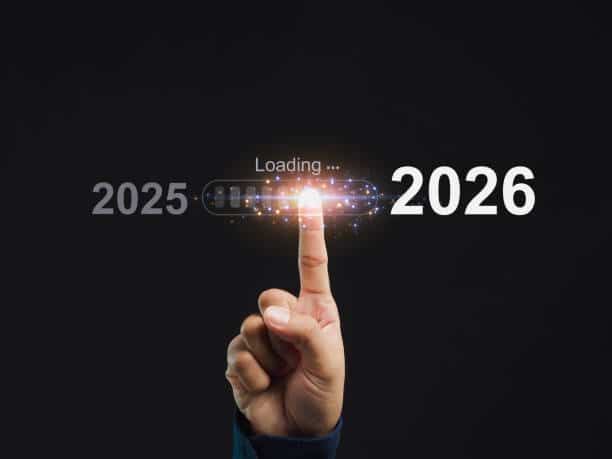Hand pointing to a digital loading bar transitioning from 2025 to 2026, symbolizing progress and the new year.
Image Source: iStock / Getty Images (Image ID: 2166396817)