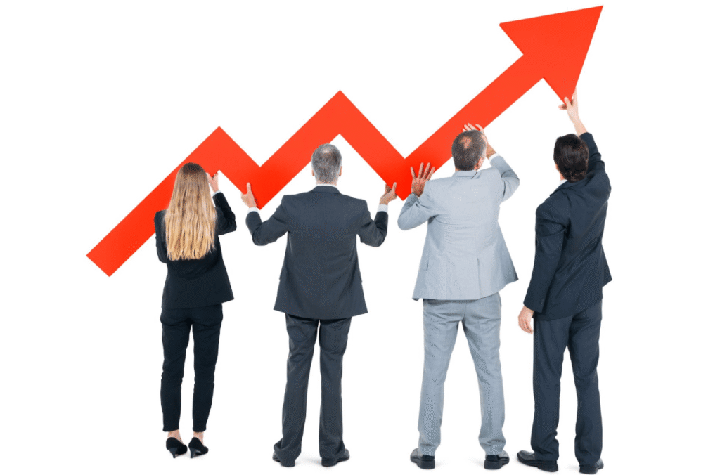 Business professionals holding up an upward arrow, representing career growth and progress.