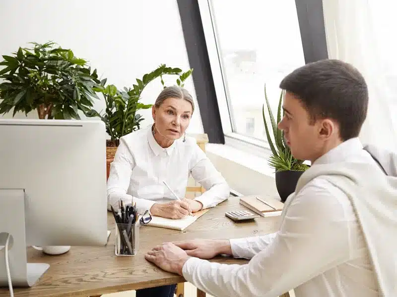 A manager discussing performance with an employee. 