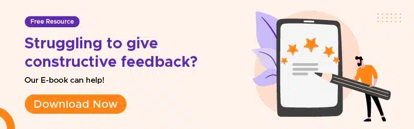 Banner advertising a free e-book for those "Struggling to give constructive feedback," featuring an illustration of a person writing on a large smartphone displaying stars.